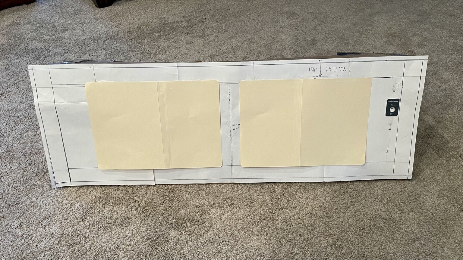 Cardboard chartplotter templates and a sample switch positioned on the pilothouse console prototype