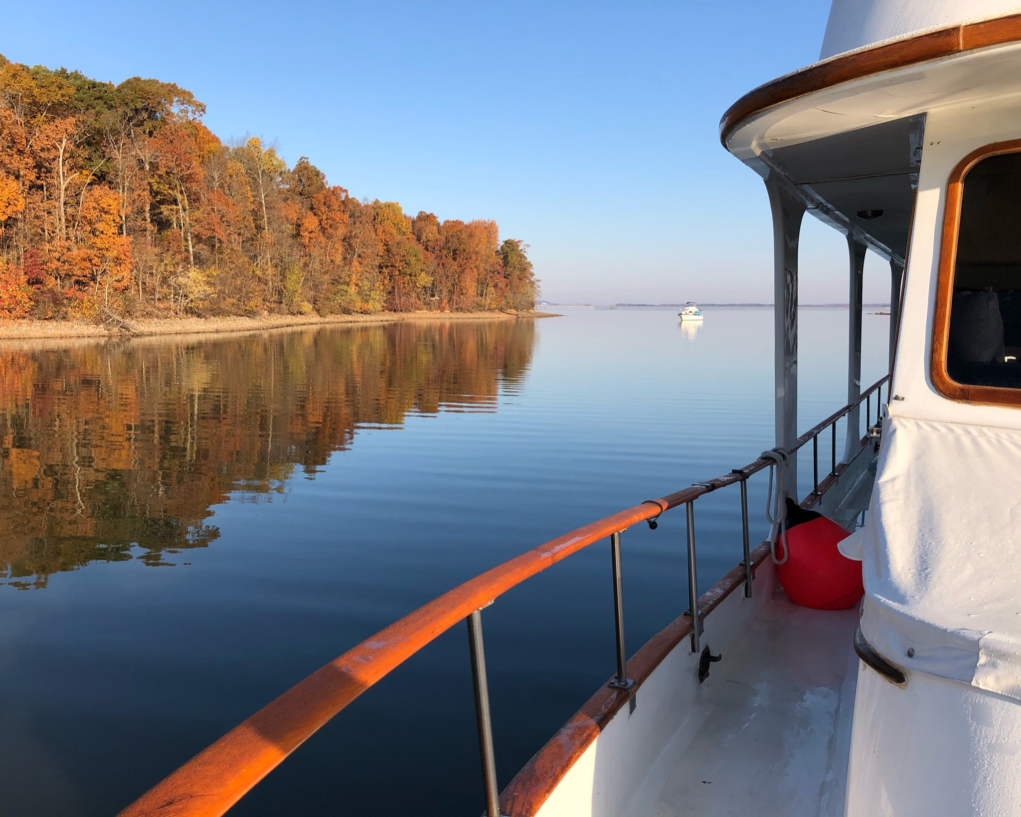 Hunky Dory’s side deck beside a calm autumn anchorage