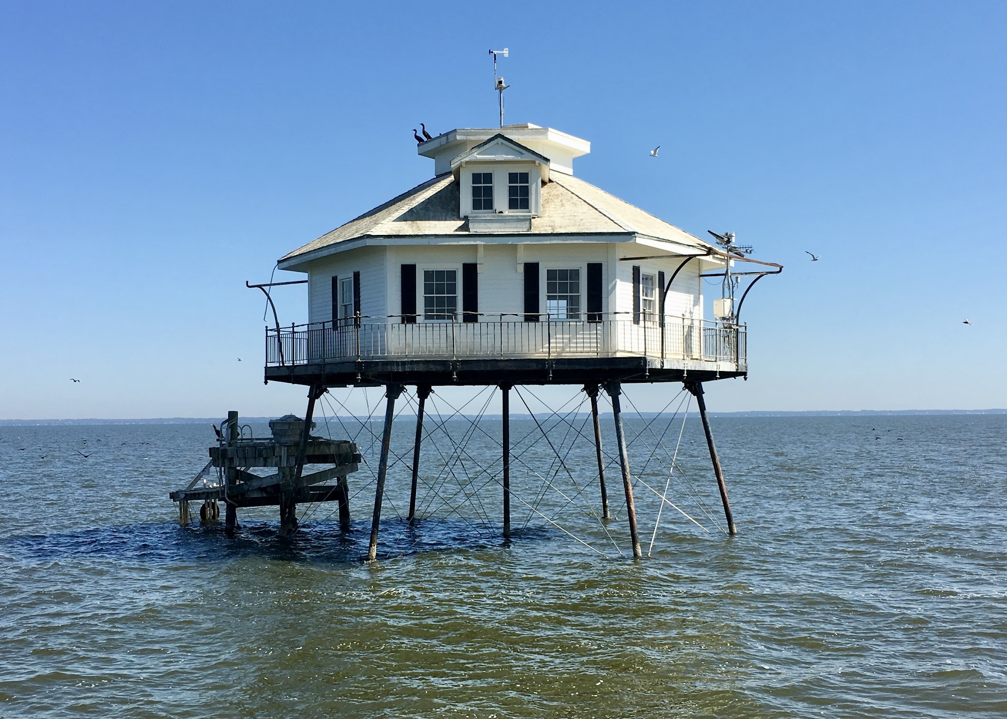 Middle Bay Lighthouse standing on iron pilings in Mobile Bay