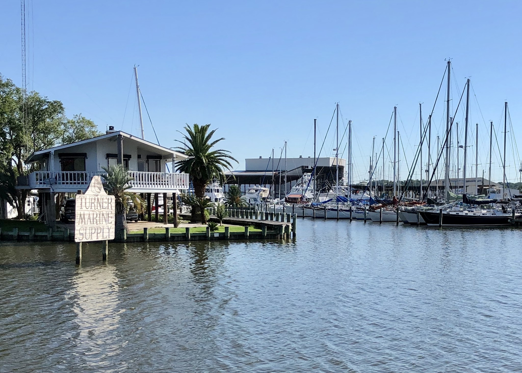 Turner Marine’s waterfront building and sailboat docks on Dog River