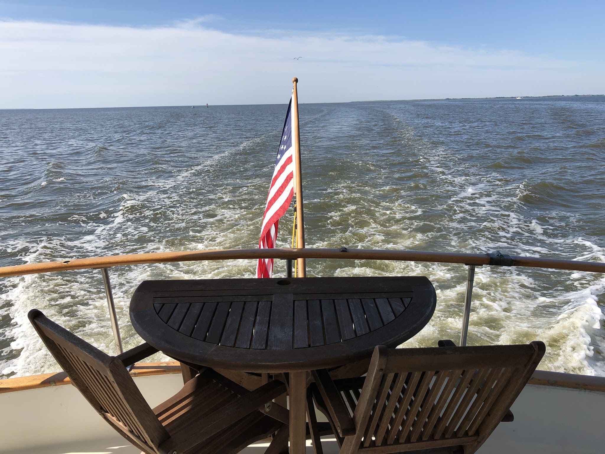 Hunky Dory’s wake and American flag viewed from the stern while crossing Mobile Bay