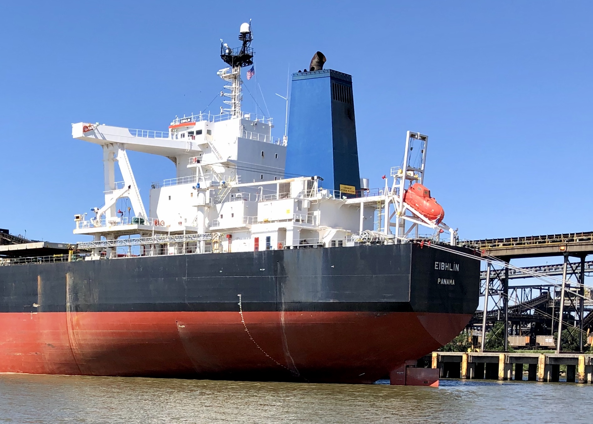 A large tanker moored along Mobile’s industrial waterfront