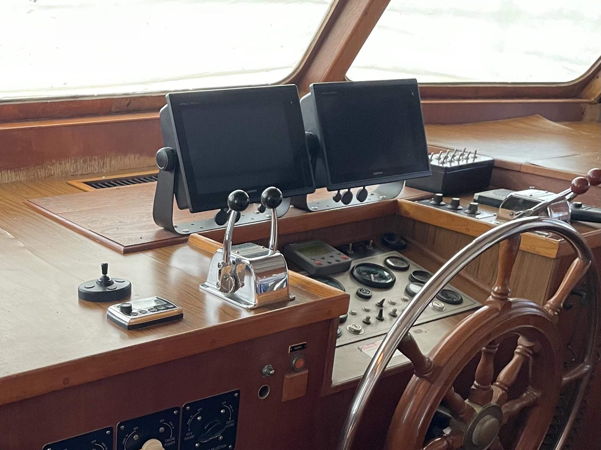 Two chartplotters mounted on brackets in front of Hunky Dory’s pilothouse instrument panel