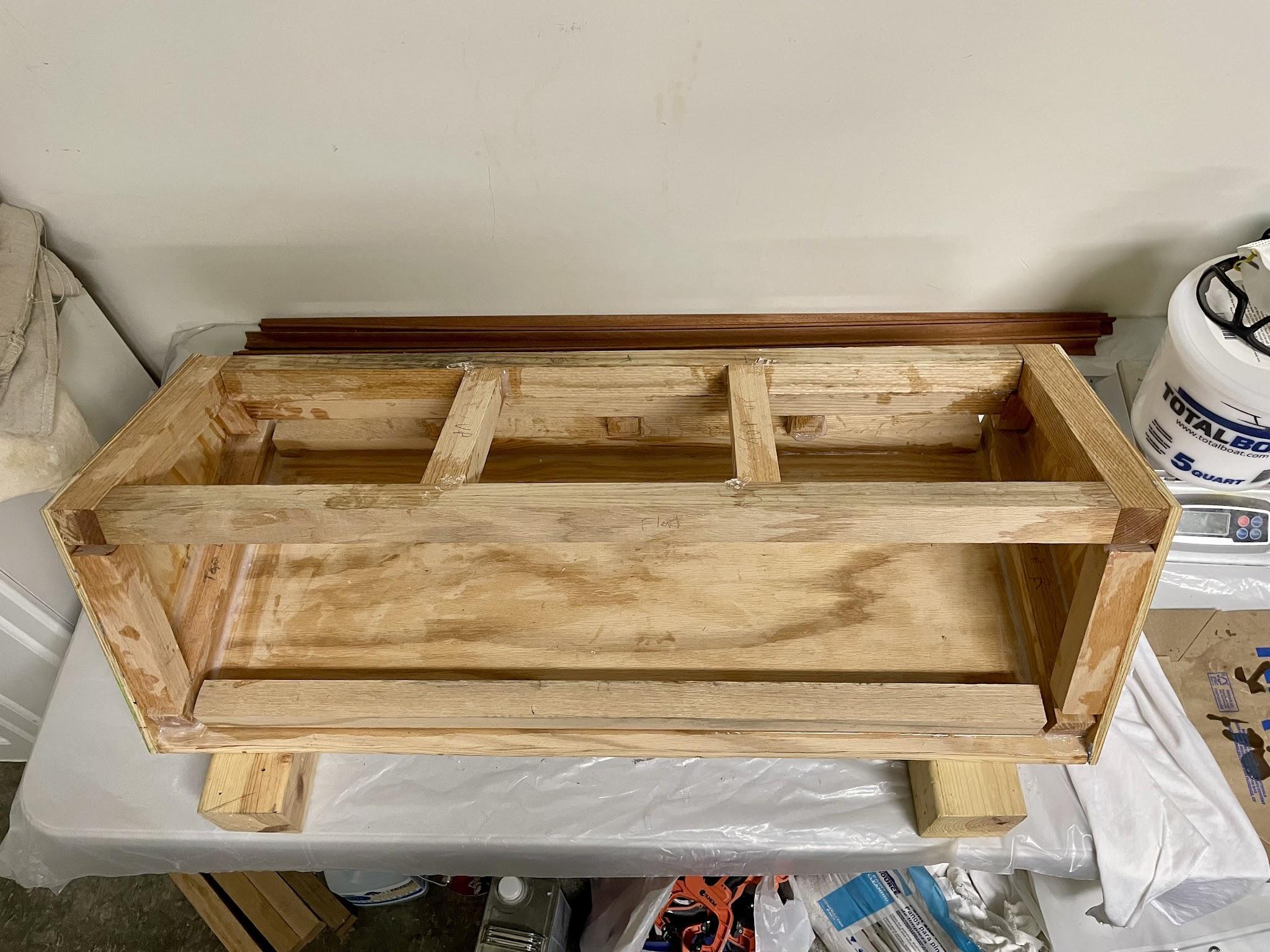 Lengthwise oak supports completing the console cabinet frame