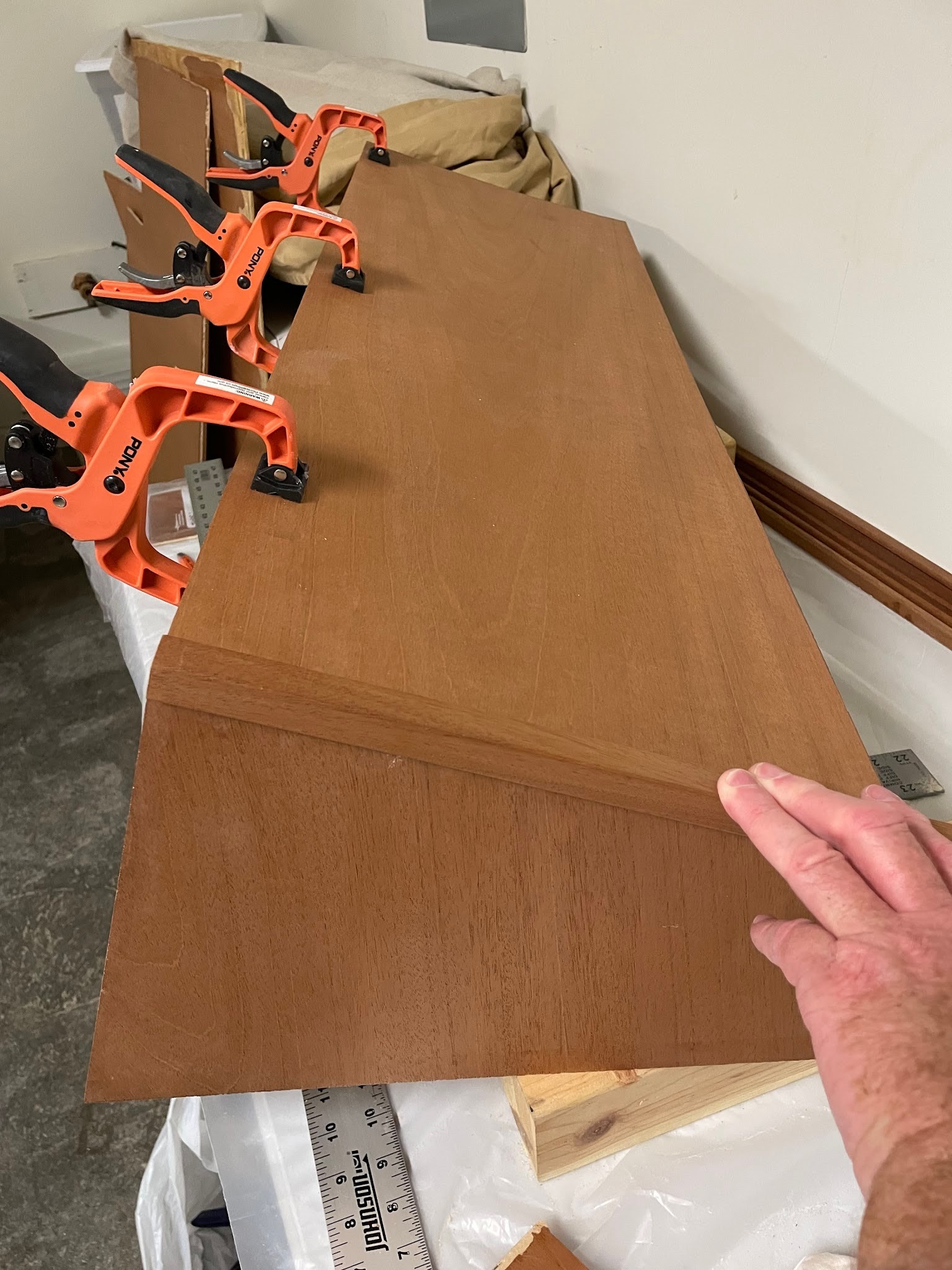 Top panel clamped and weighted while epoxy cures